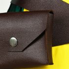 Brown waist pouch with snap closure on crossed belt