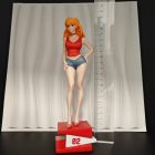 Asuka figurine with 02 base next to a ruler for scale context
