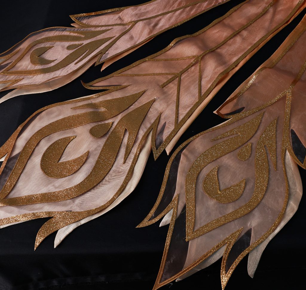 Detail of phoenix costume's layered embroidered rear panels