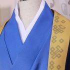 Blue inner layer and gold-trimmed navy outer robe at the neckline