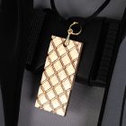 Gold-tone textured pendant against male Rover gray costume top