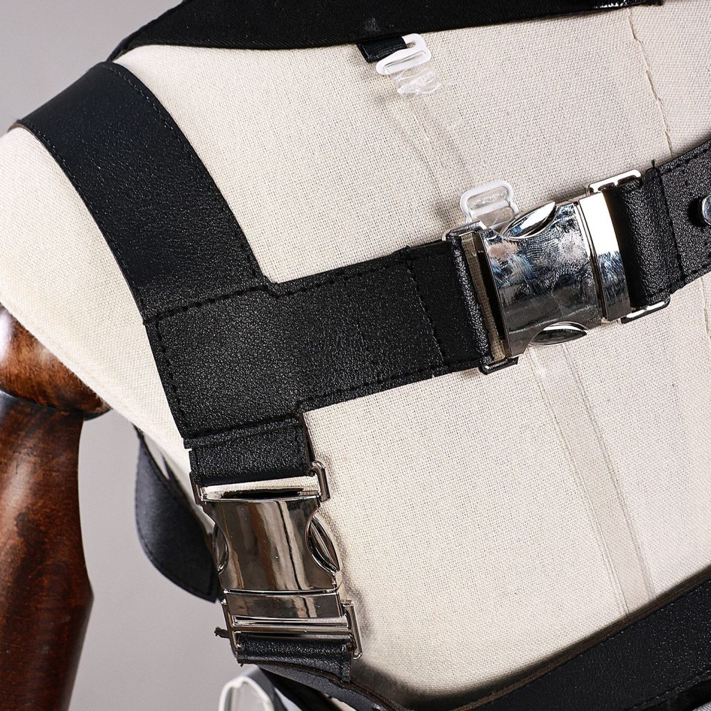 Black shoulder strap and silver fastener detail on male Rover costume