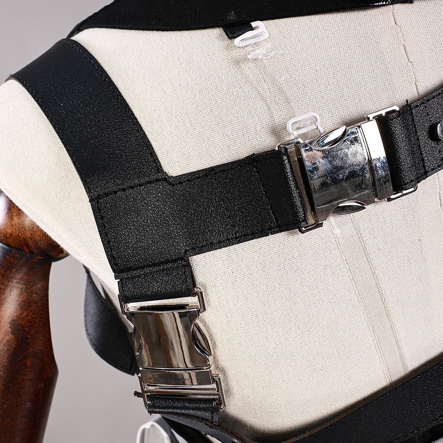 Black shoulder strap and silver fastener detail on male Rover costume
