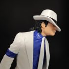 White suit figure detail showing fedora, blue shirt and jacket