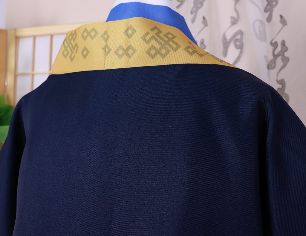 Navy outer robe from the back with patterned gold shoulder panel