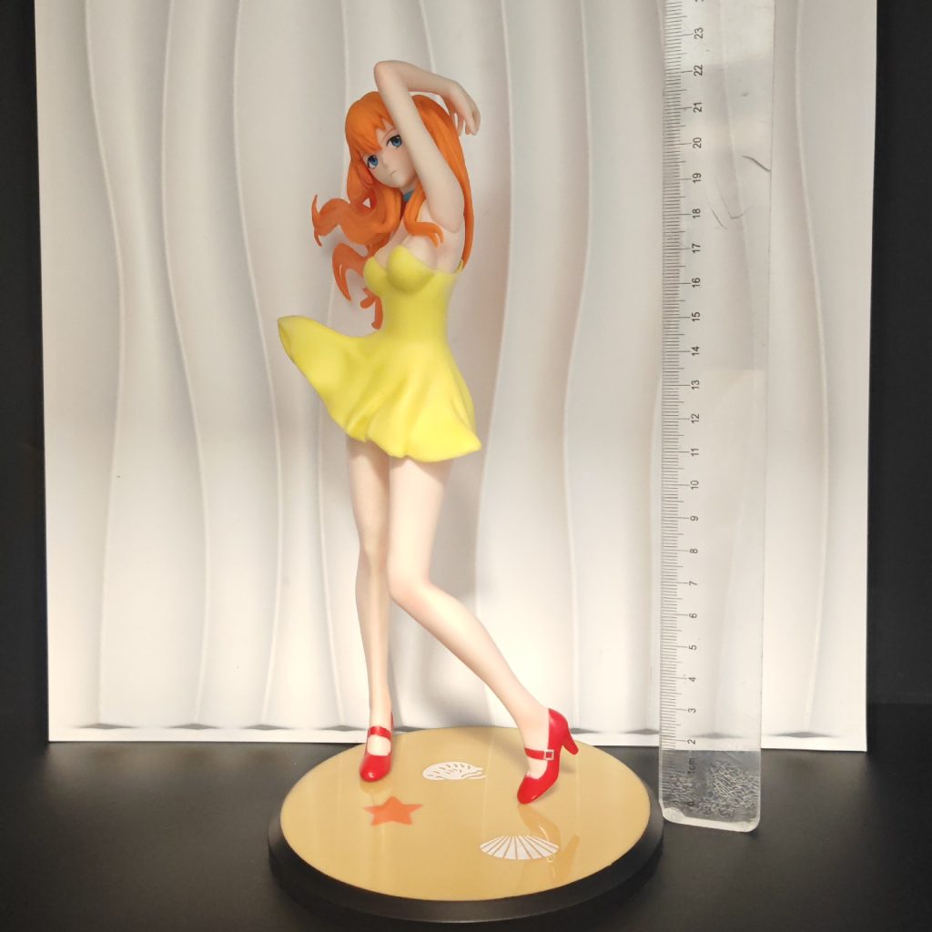 Asuka display figure and round base beside metric ruler for scale