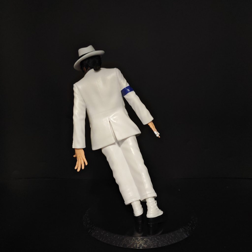 Rear of white suit leaning pose figure on round base