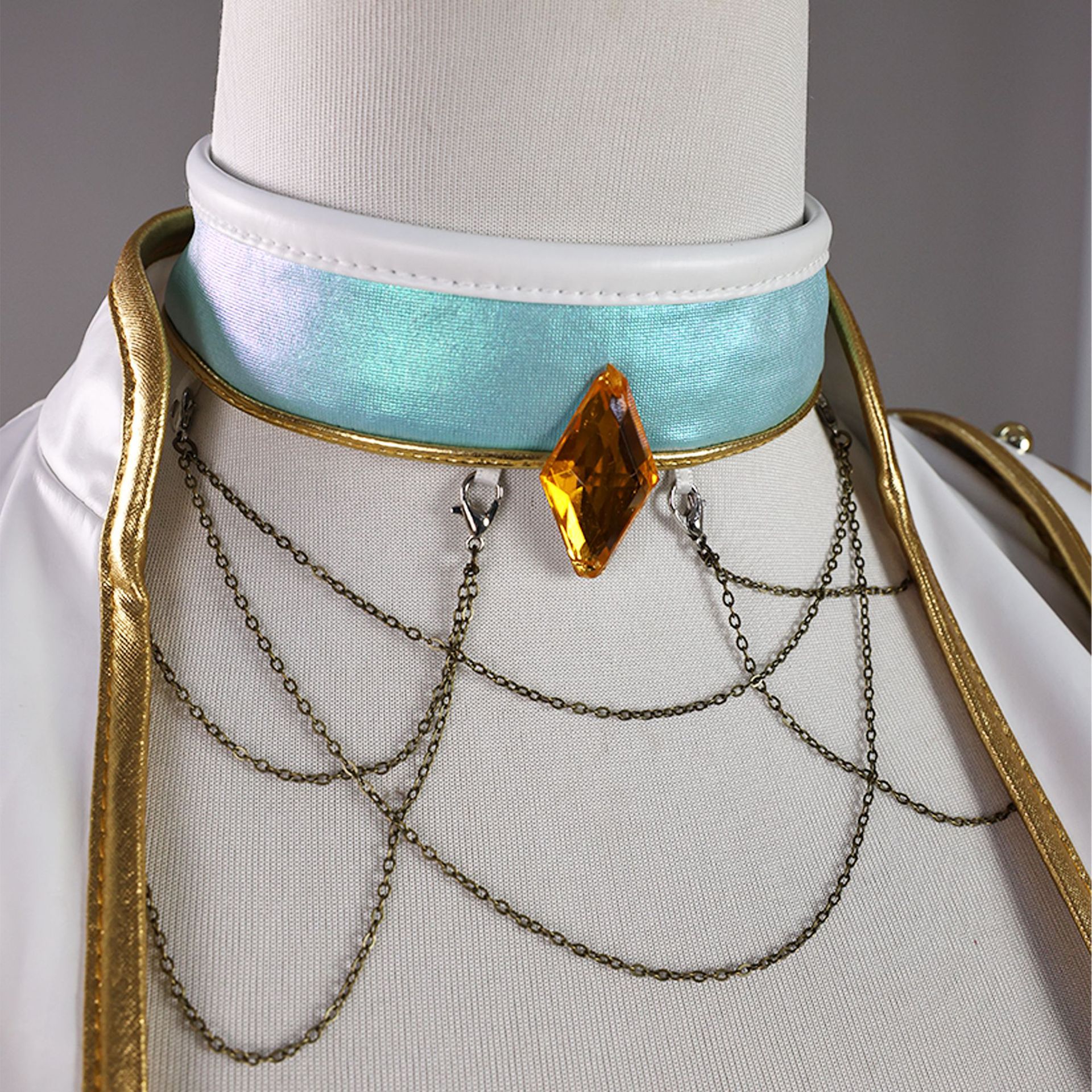Child Mira blue choker detail with amber-colored diamond ornament and draped chains