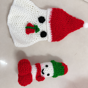 Christmas crochet ghost in a red hat beside its red-and-white companion figure