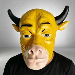Front view of a yellow bull mask with black horns and a pale muzzle being worn