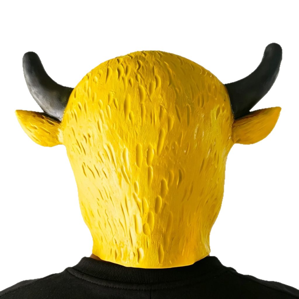 Rear view of a yellow bull mask being worn, showing the textured back, black horns and pointed ears