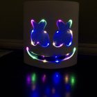 Multicolor illuminated smile and X eyes in low light