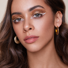 Gold star and dot eye transfers worn with graphic eyeliner