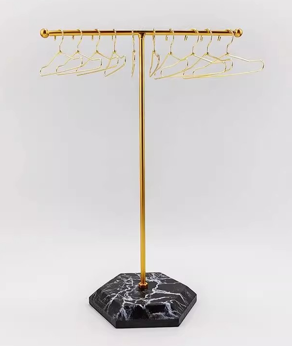 Gold miniature display rack with dark hexagonal base and ten gold hangers