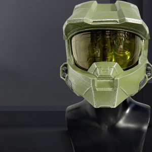 Olive-green Master Chief cosplay helmet with gold visor on a display bust