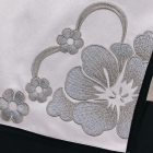 Silver floral embroidery and black piping on white costume fabric