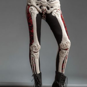 Cream bone-pattern leggings with black and red panels worn with boots