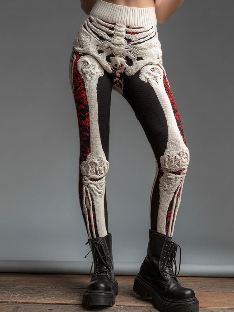 Cream bone-pattern leggings with black and red panels worn with boots