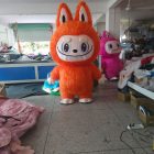 Orange Labubu-style walking mascot