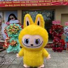 Yellow Labubu-style walking mascot outdoors