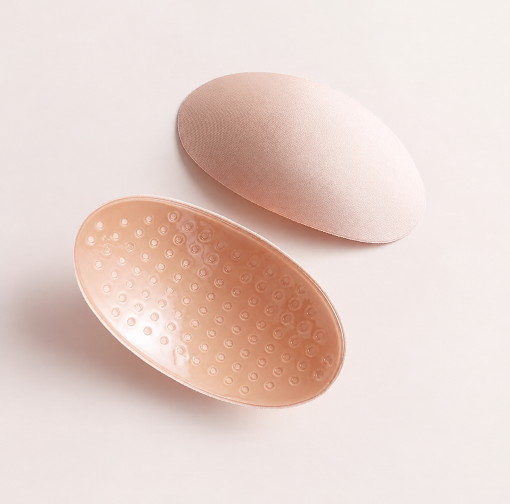 Nude ventilated sponge shoulder pad pair, front and underside