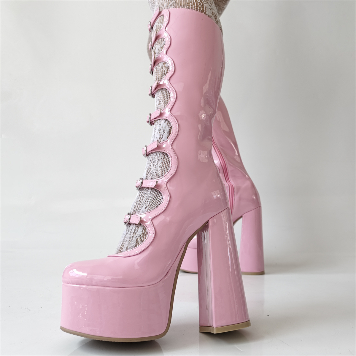Pink buckle-front platform boots — styled close-up; hosiery not included