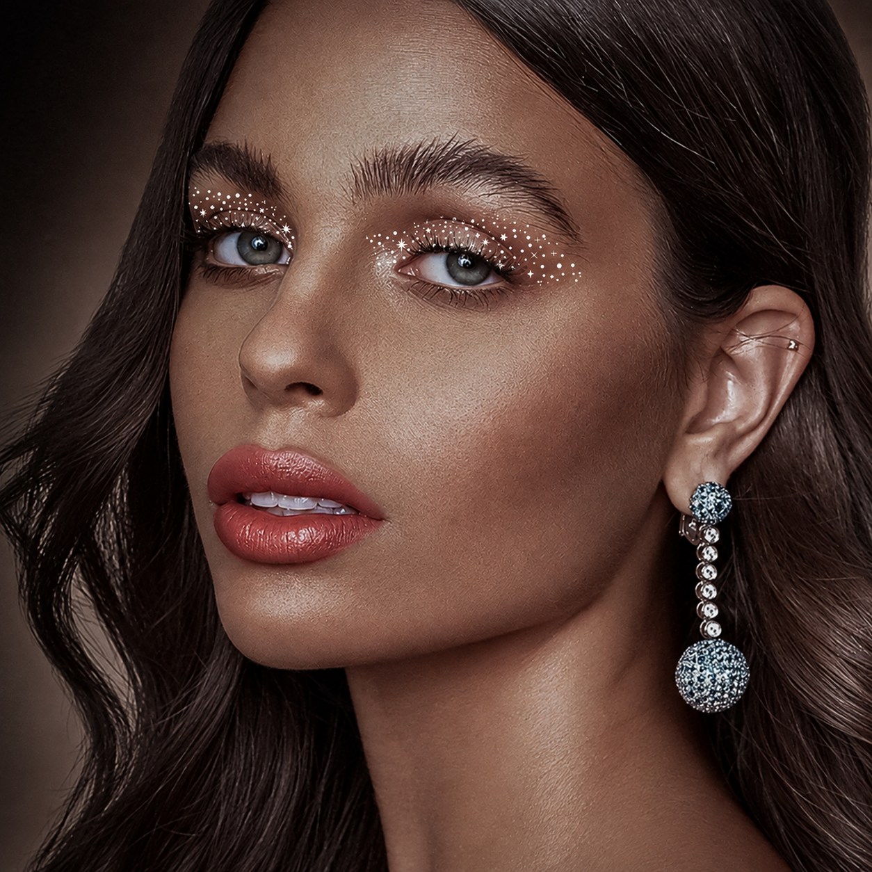Silver star and dot eye transfers worn across the upper eyelids