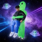 Adult inflatable alien carrying costume in space-themed setting