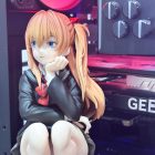 Side angle of Asuka figurine with orange twin tails and red bow
