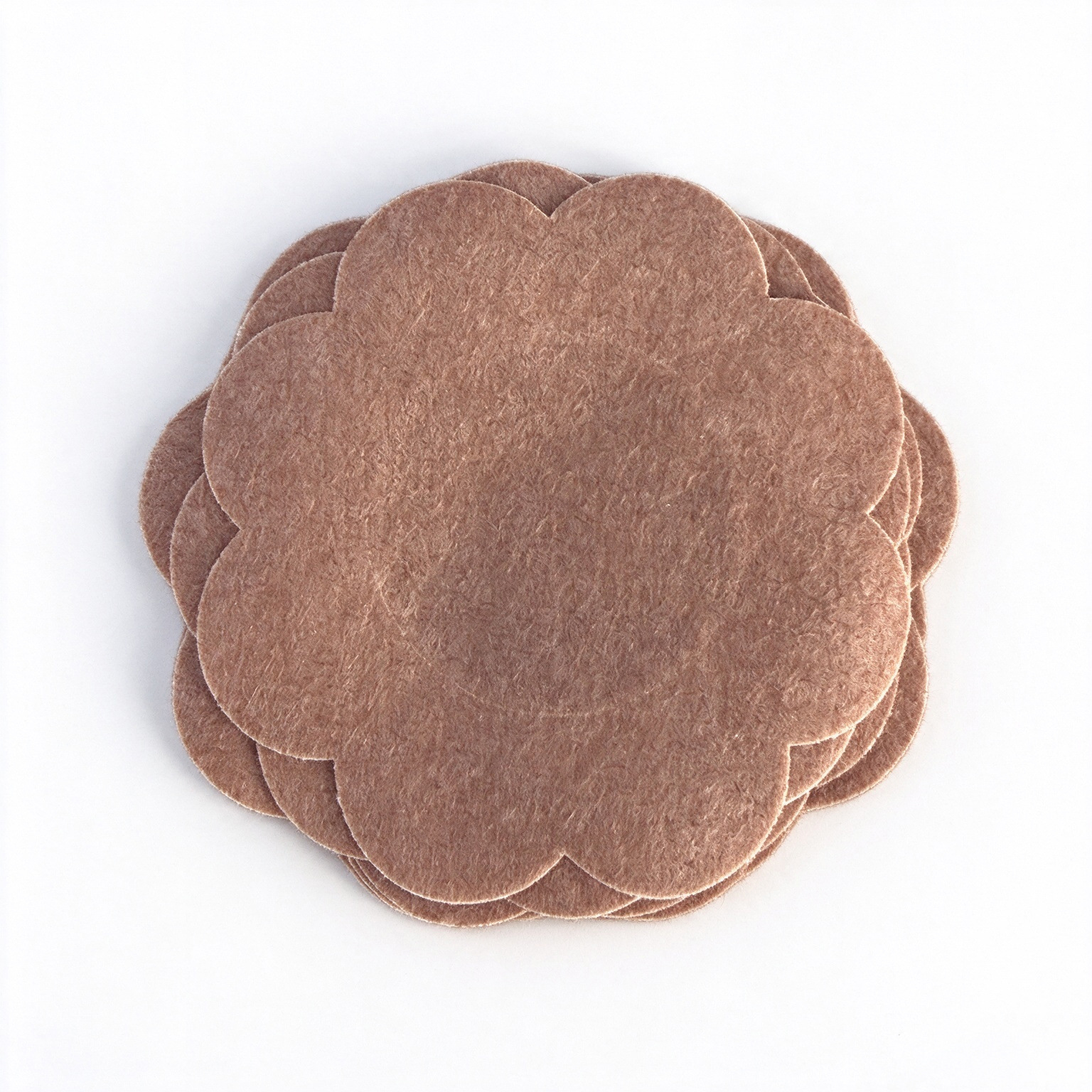 Flower-Shaped Adhesive Breast Cover Patches — 10 Pieces 9 Stack of brown flower-shaped adhesive covers showing the scalloped shape