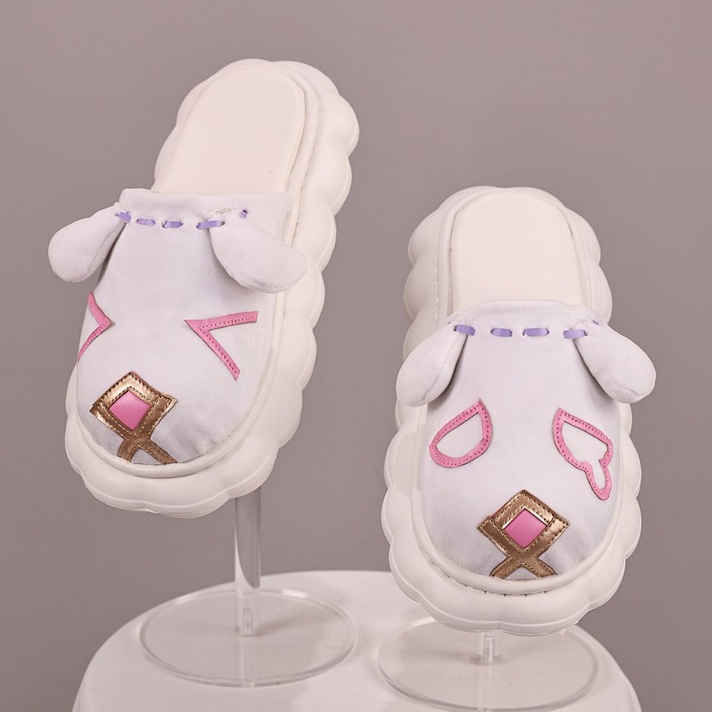 Pair of white cat-face slip-on shoes with pink and gold details