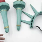 Close detail of red and gold torches beside seven-ray crown and elastic