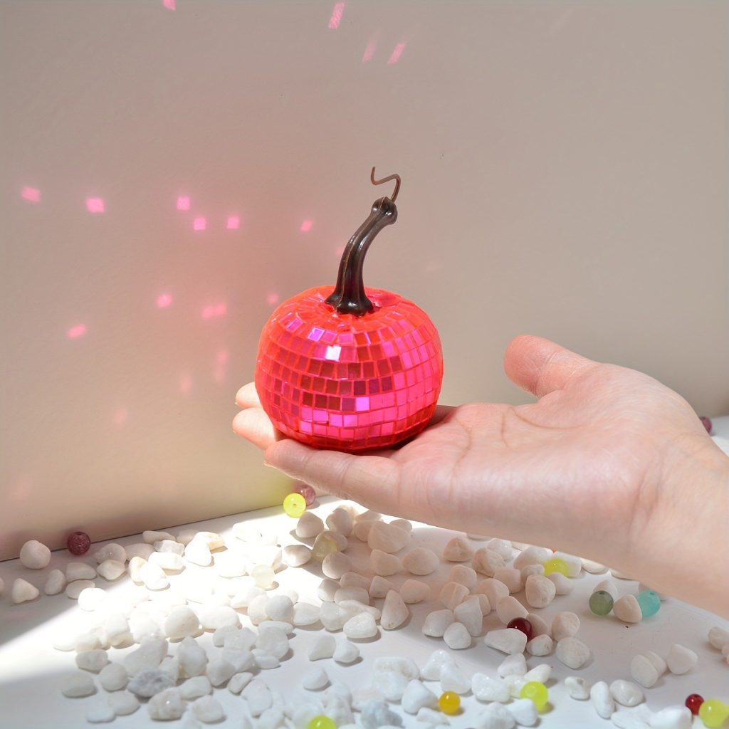 Small pink mirrored disco pumpkin in hand