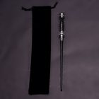 Black wand with silver-banded handle beside its drawstring pouch