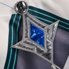 Close-up of blue jewel and silver embroidered costume detail