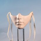 Beige mechanical lower-face mask and tie ribbons