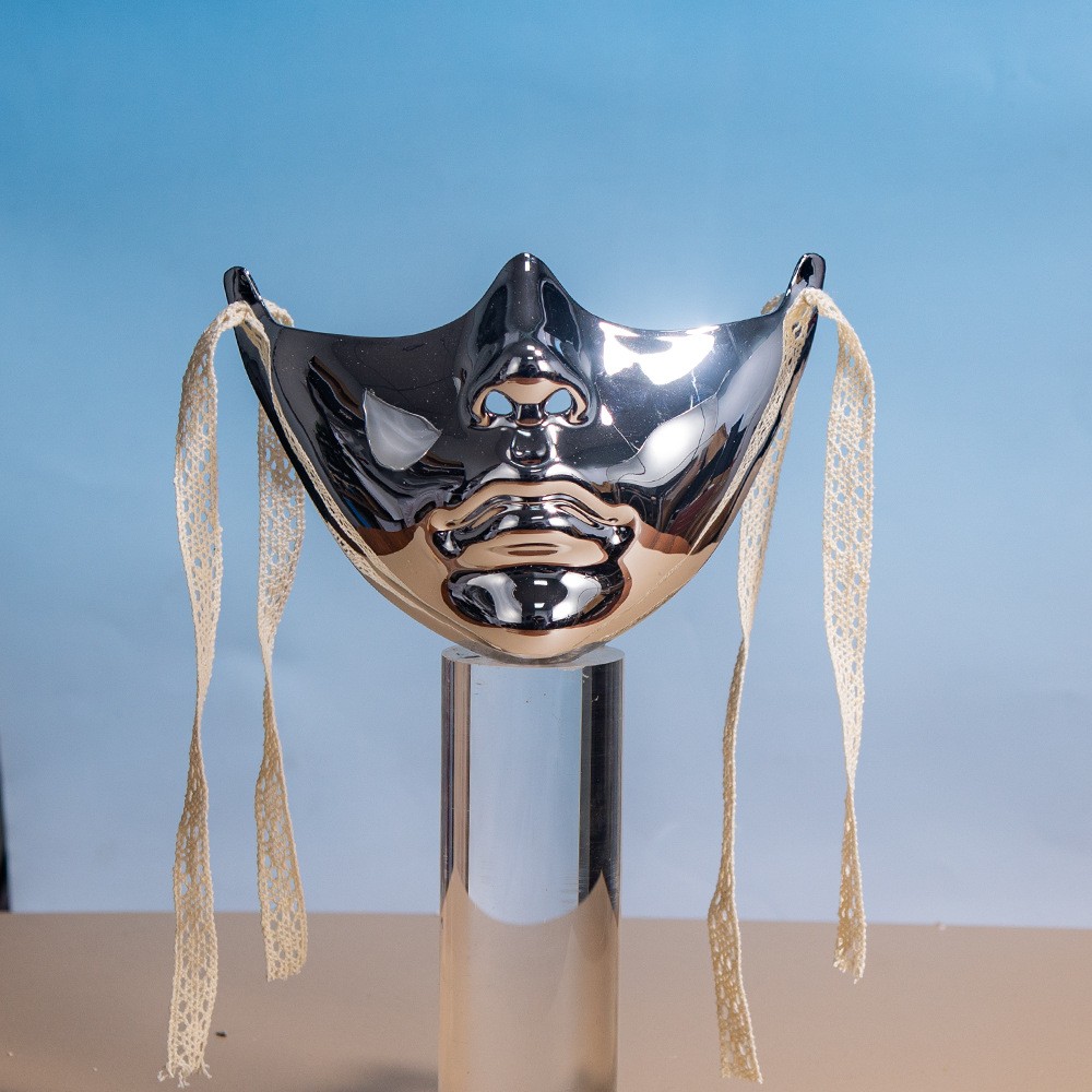 Silver sculpted lower-face mask photographed from the front