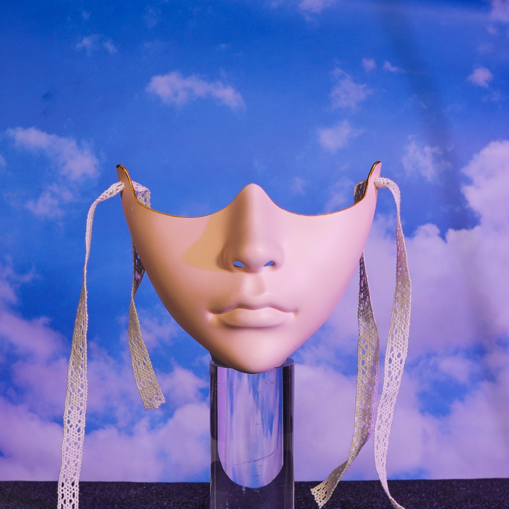 Beige sculpted lower-face mask with smooth lip contours