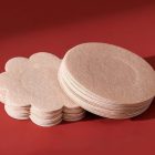 Dark beige flower-shaped adhesive patch stack beside circular example