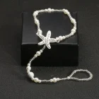 Starfish centerpiece and pearl-style bead strand detail