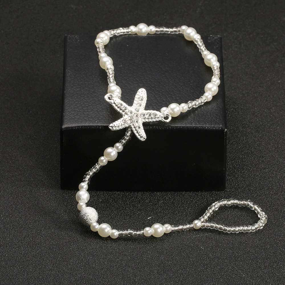 Starfish centerpiece and pearl-style bead strand detail